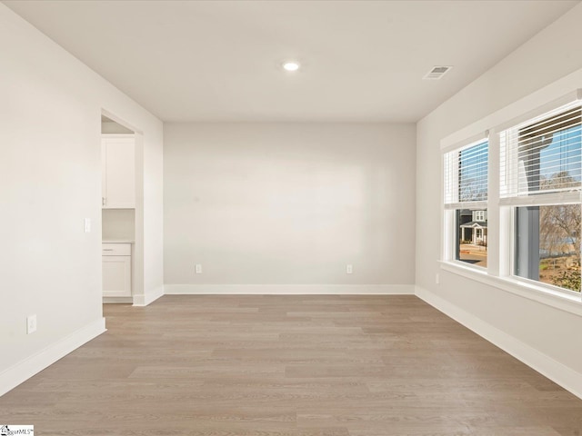 spare room with light hardwood / wood-style floors