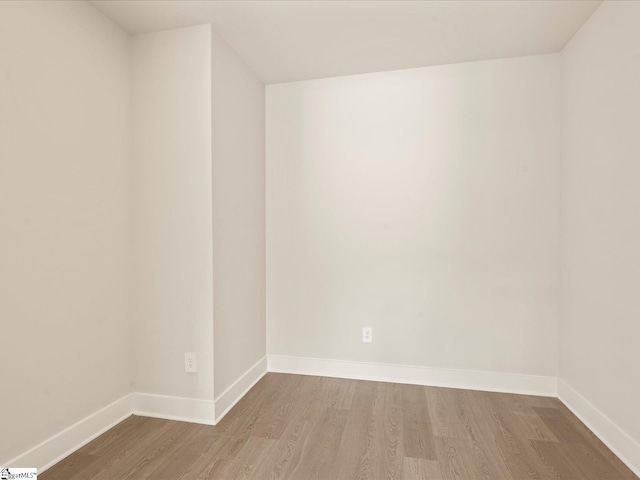 empty room with hardwood / wood-style floors