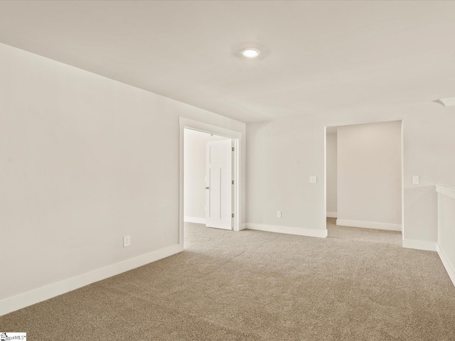 unfurnished room with light colored carpet