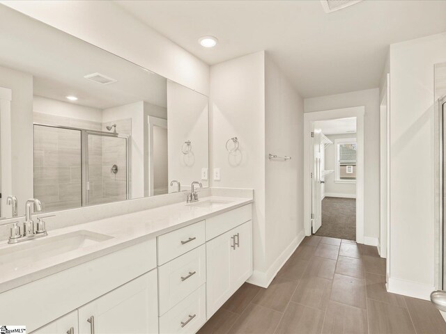 bathroom featuring walk in shower and vanity