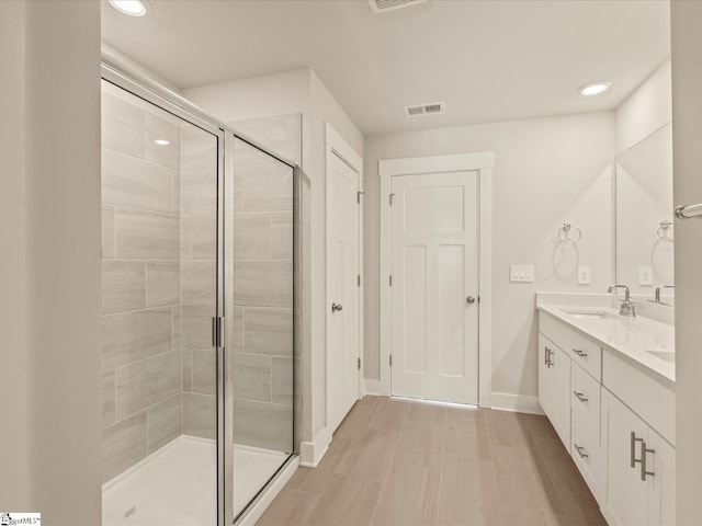 bathroom featuring an enclosed shower and vanity