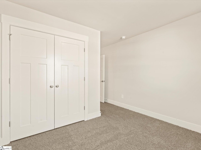 unfurnished bedroom featuring a closet and carpet