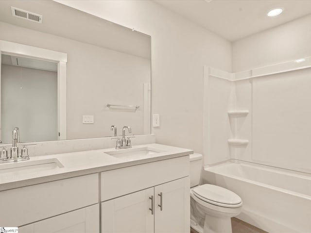 full bathroom featuring toilet, vanity, and  shower combination