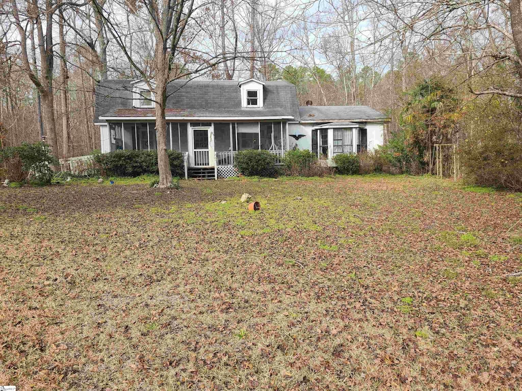 view of front of house with a sunroom