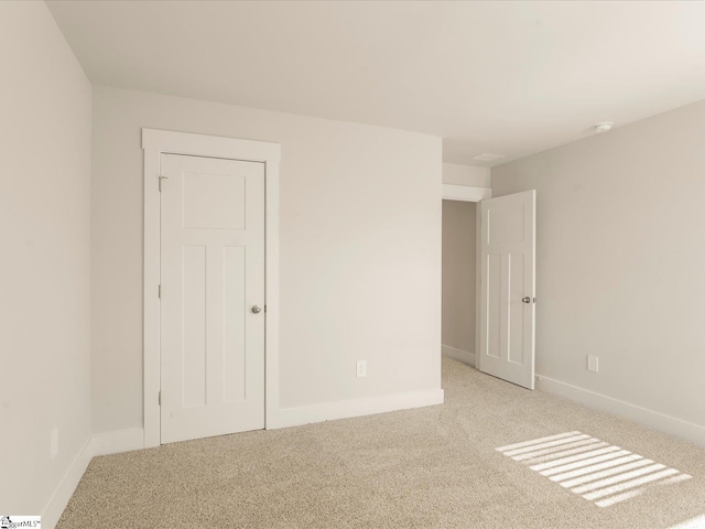 spare room with light colored carpet