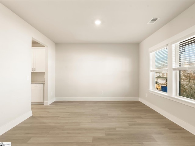 spare room featuring light hardwood / wood-style flooring