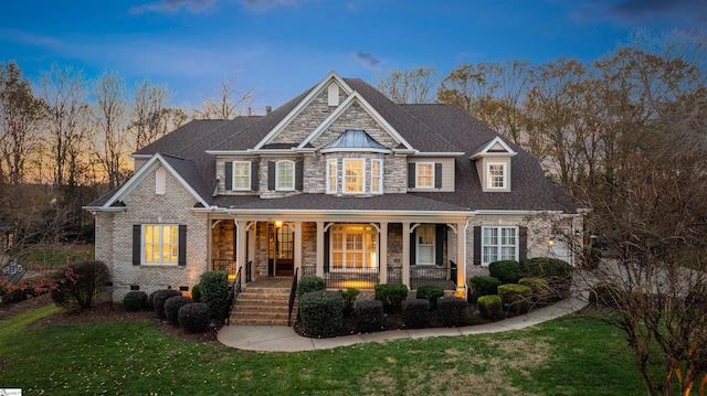 craftsman inspired home featuring a lawn and a porch