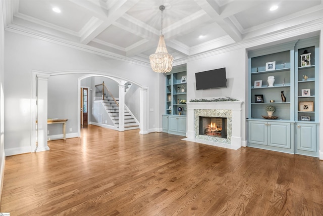 unfurnished living room with wood-type flooring, coffered ceiling, and beam ceiling