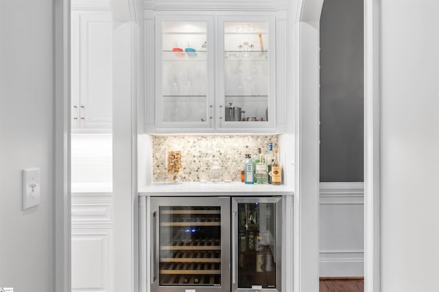 bar with white cabinets, tasteful backsplash, and wine cooler