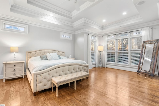 bedroom with light wood-type flooring, crown molding, and multiple windows