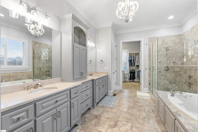 bathroom with vanity, ornamental molding, shower with separate bathtub, and an inviting chandelier