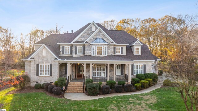 view of front of home featuring a front lawn and a porch