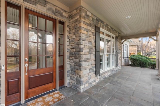 view of exterior entry with a porch