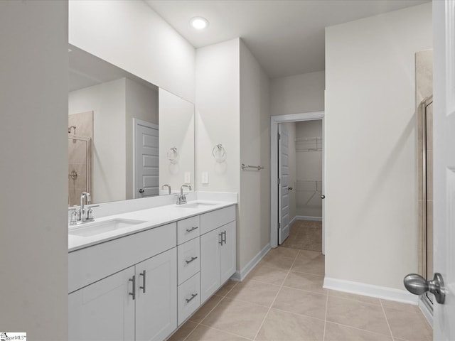 bathroom featuring vanity, an enclosed shower, and tile patterned flooring