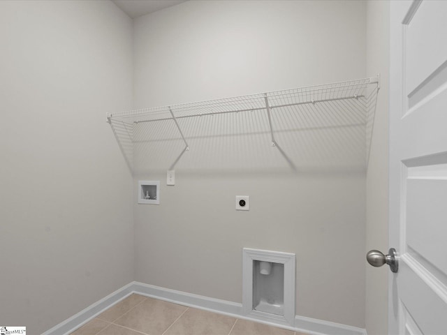 laundry area with electric dryer hookup, washer hookup, and light tile patterned floors