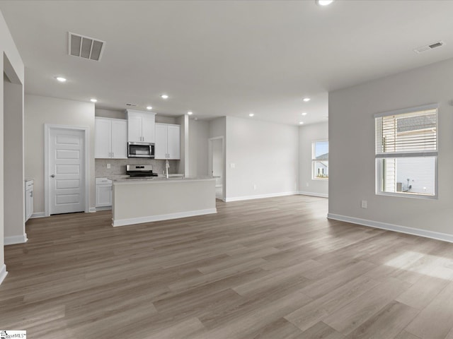 unfurnished living room with light wood-type flooring