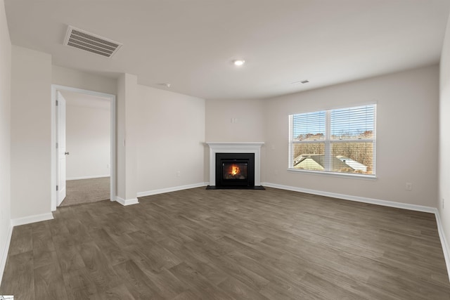 unfurnished living room featuring dark hardwood / wood-style floors