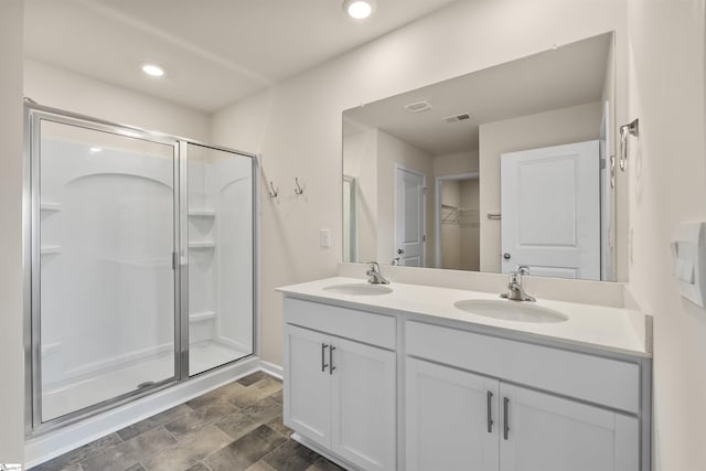 bathroom featuring hardwood / wood-style floors, vanity, and a shower with door