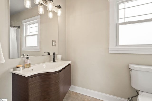 bathroom with tile patterned flooring, vanity, and toilet