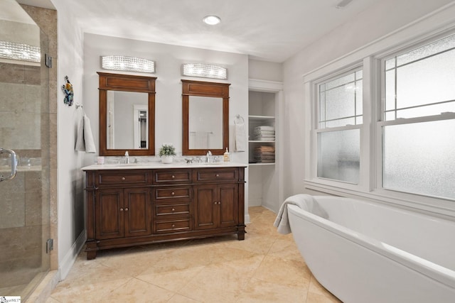 bathroom featuring tile patterned floors, vanity, and shower with separate bathtub