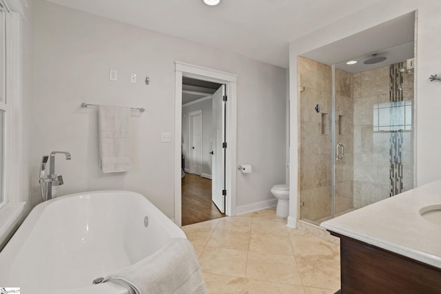 full bathroom with tile patterned floors, vanity, shower with separate bathtub, and toilet