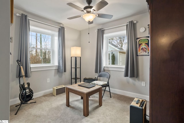 sitting room featuring light colored carpet, a wealth of natural light, and ceiling fan