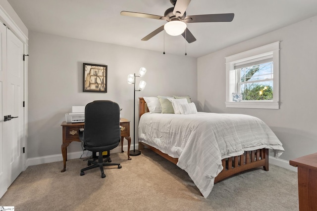 bedroom featuring ceiling fan and light carpet