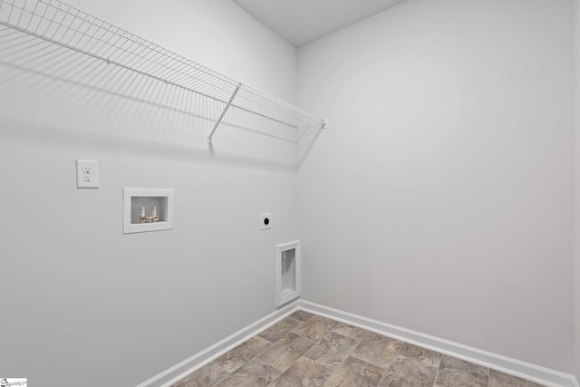 clothes washing area featuring hookup for a washing machine, baseboards, hookup for an electric dryer, laundry area, and stone finish floor