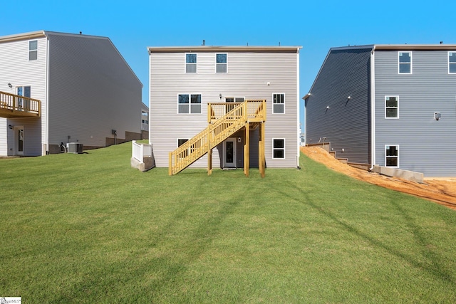 rear view of house featuring stairs, a deck, cooling unit, and a lawn