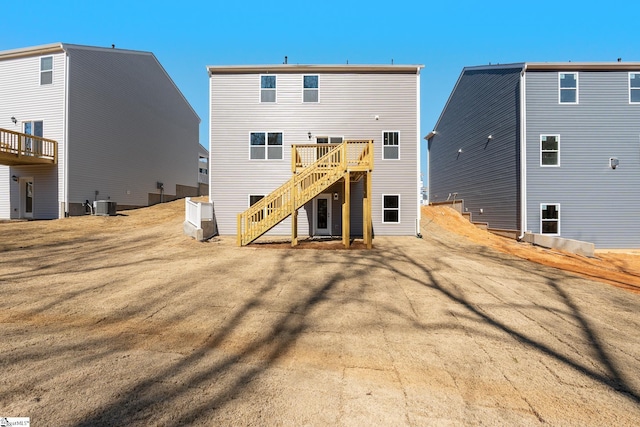 back of house with stairway, a wooden deck, and central AC