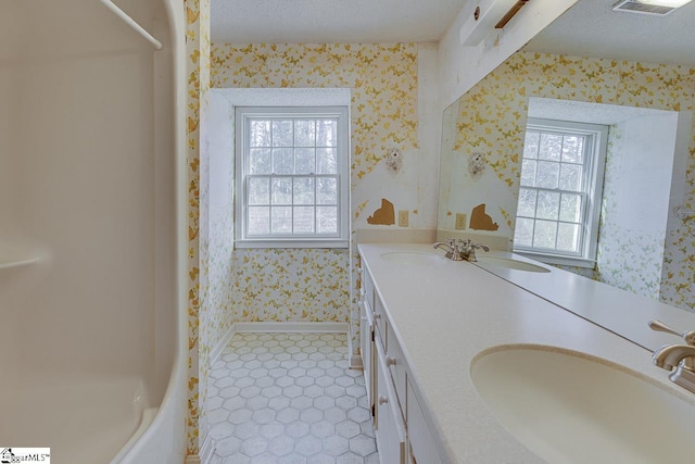 bathroom featuring a textured ceiling and vanity