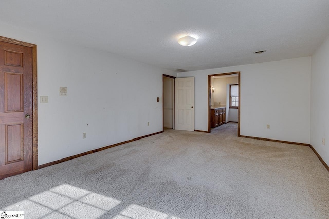 carpeted spare room featuring a textured ceiling