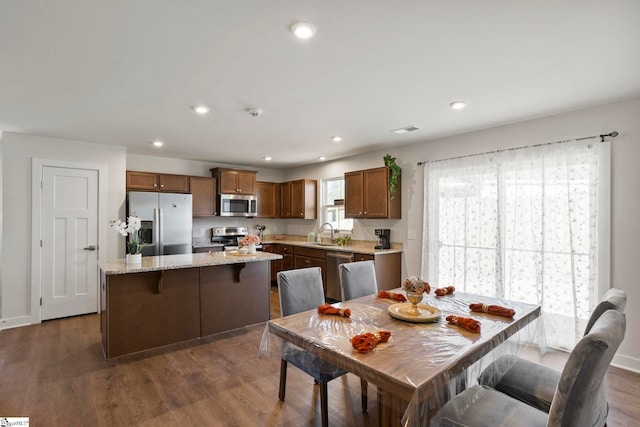 dining area featuring dark hardwood / wood-style floors and sink