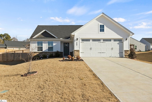 view of front of property featuring a garage and a front lawn