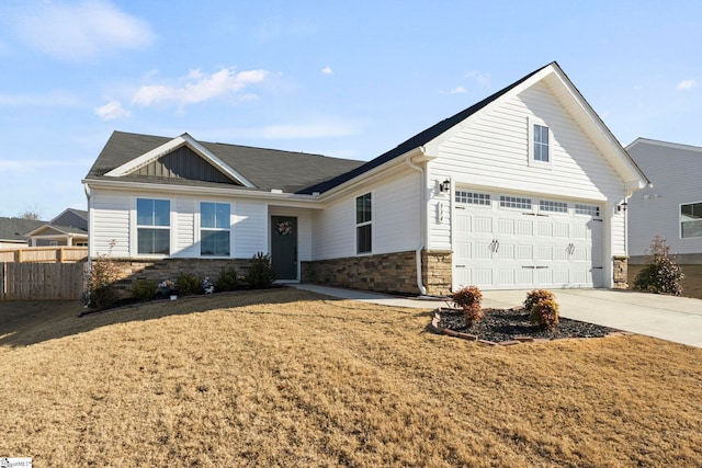 ranch-style home with a garage and a front lawn