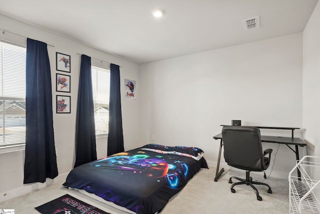 carpeted bedroom with multiple windows