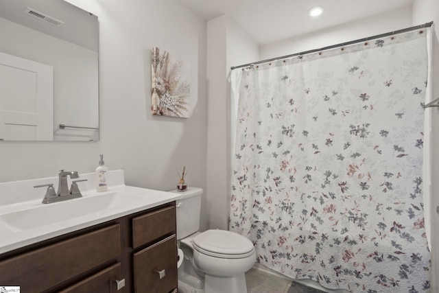 bathroom featuring tile patterned floors, vanity, and toilet