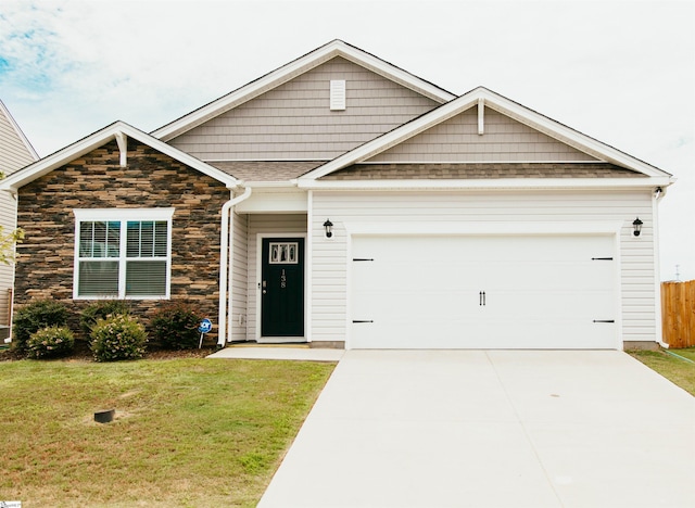 craftsman-style house featuring a front yard and a garage