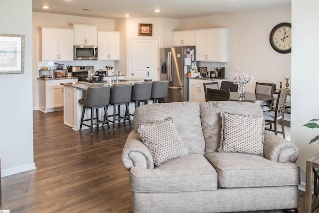 living room with dark hardwood / wood-style flooring