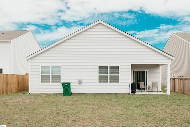 back of house featuring a yard and a patio area