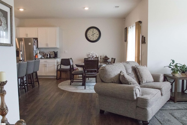 living room with dark hardwood / wood-style flooring