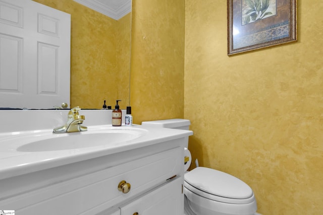 bathroom featuring vanity, toilet, and crown molding