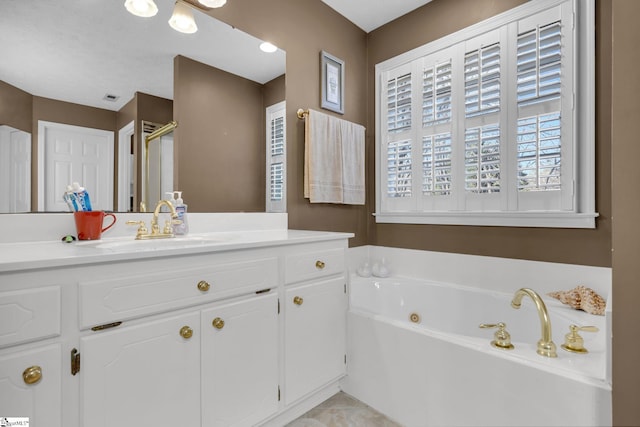 bathroom featuring vanity and a tub to relax in