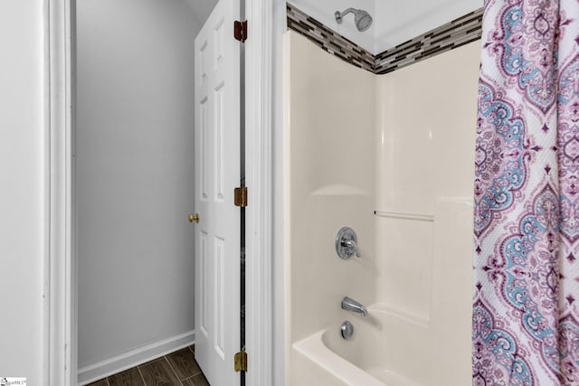 bathroom with wood-type flooring and shower / bath combo