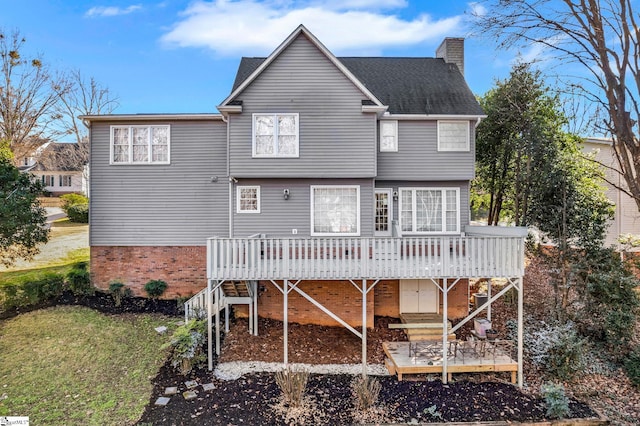 rear view of property with a lawn and a wooden deck