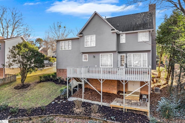 back of house featuring central AC and a deck