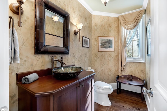 bathroom with crown molding, toilet, vanity, and hardwood / wood-style flooring