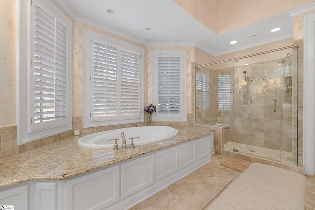 bathroom with ornamental molding and independent shower and bath