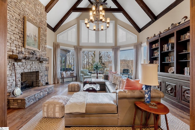 living room with a fireplace, beam ceiling, high vaulted ceiling, and a healthy amount of sunlight