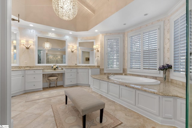 bathroom featuring a washtub, vanity, and an inviting chandelier